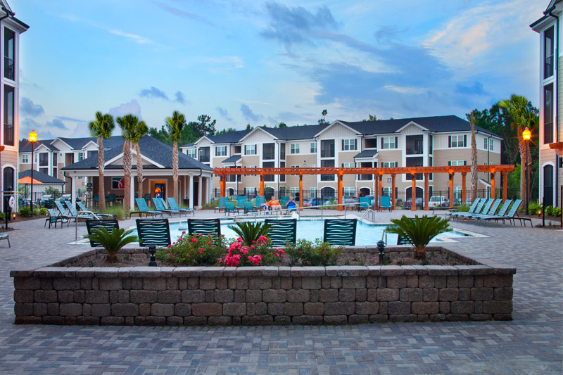 Abberly Crossing’s resort-style pool, deck chairs, and landscaping.
