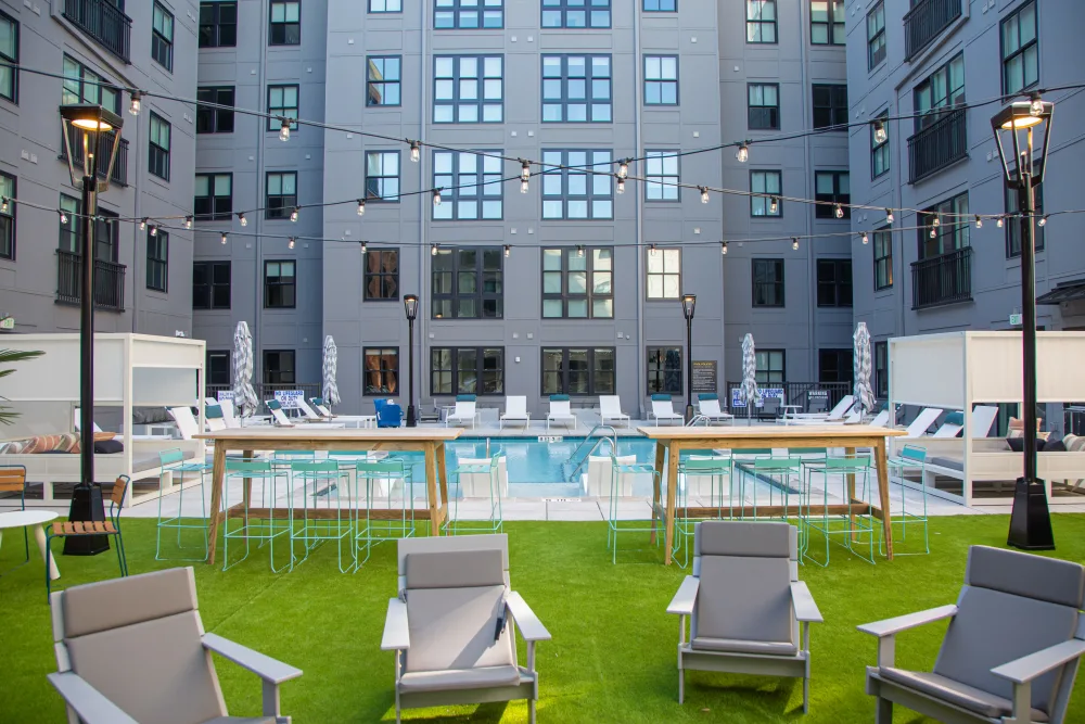 511 Meeting pool area with lounge chairs surrounded by apartments