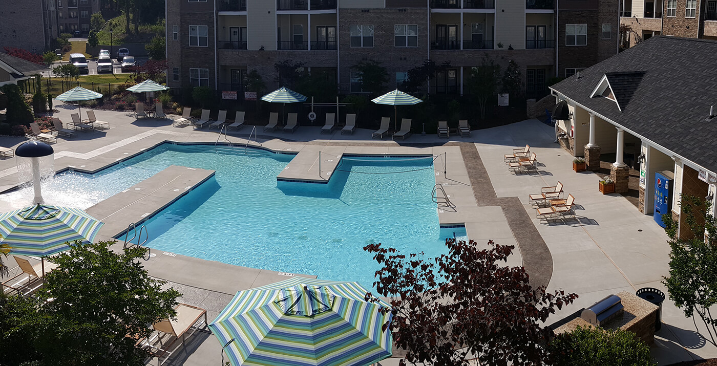 Arbors at Fort Mill zero-entry pool with lounge chairs and umbrellas