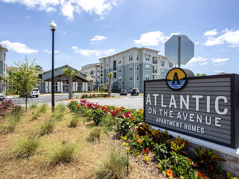 Entrance sign and view of Atlantic on the Avenue apartment homes.